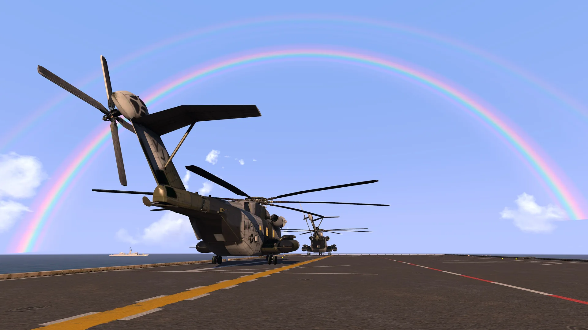 Helicopters on a carrier deck under a rainbow