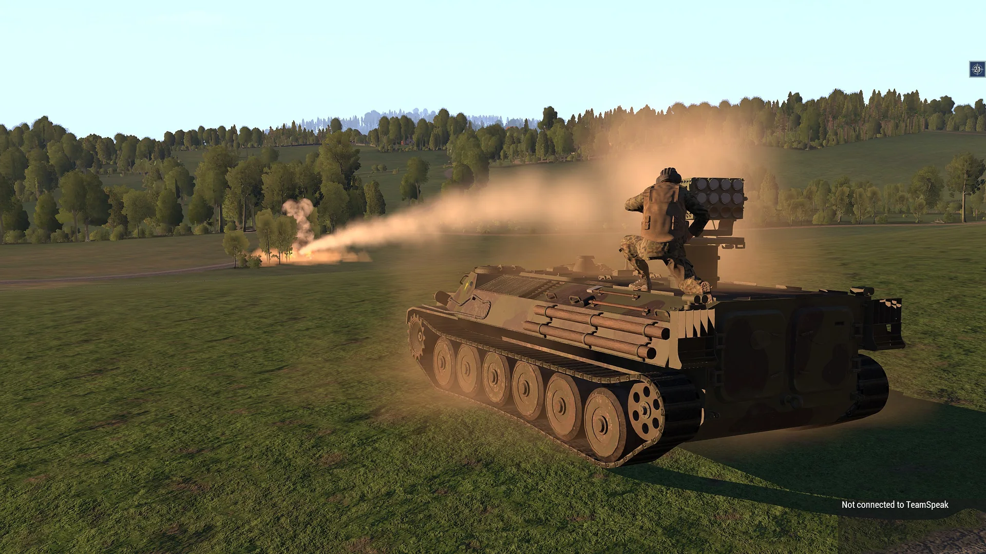 A tracked rocket launcher firing