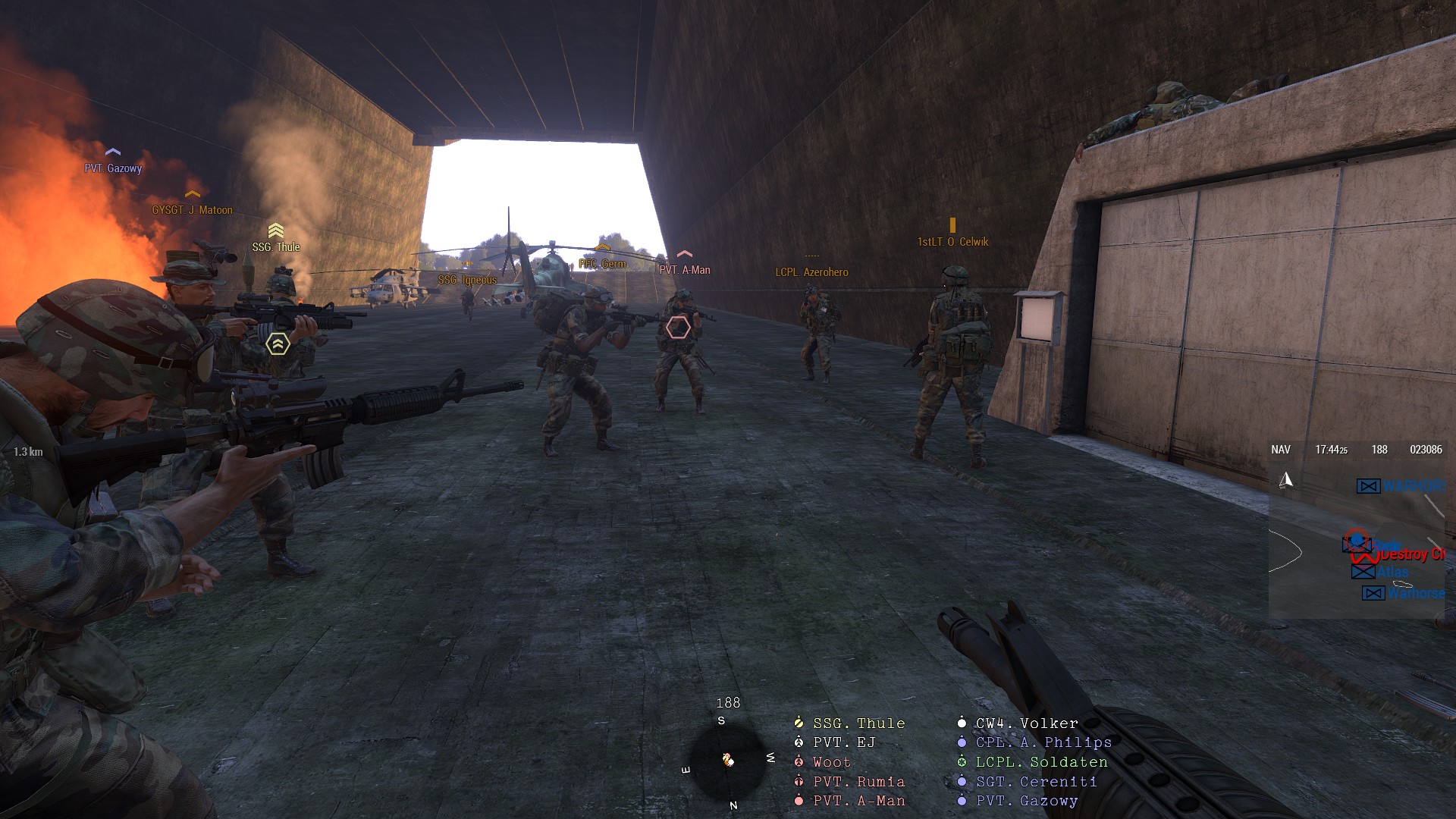 Players moving through a burning breach