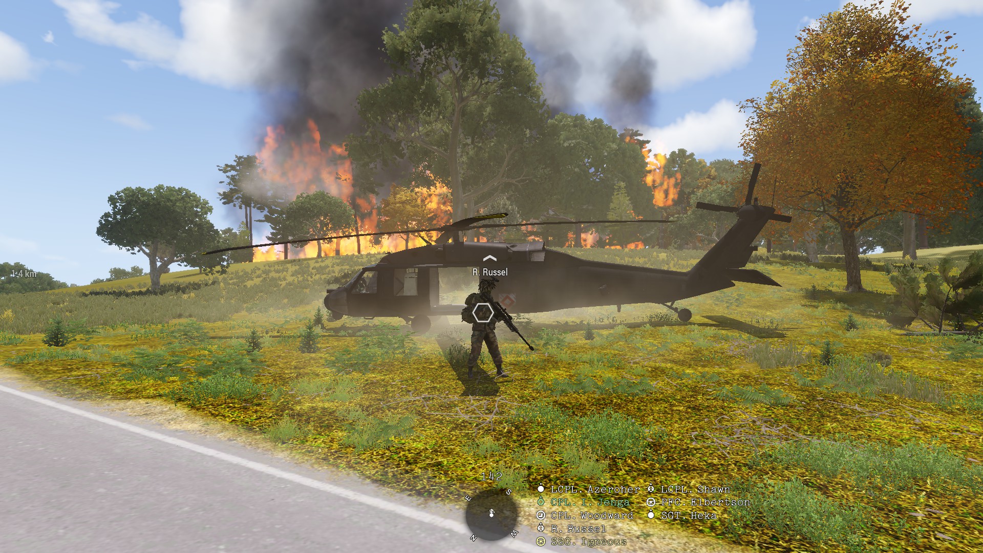 A helicopter landing near a burning position